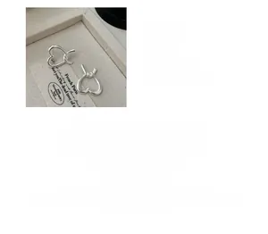 Macro detail of S925 sterling silver matte heart earrings with vintage twisted texture