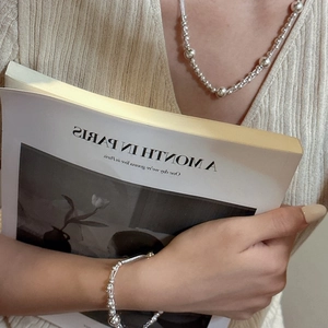 Minimalist 925 sterling silver beaded multilayer necklace worn by model in a chic style