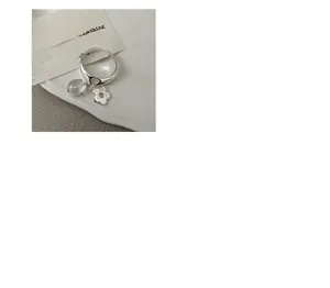 Detail of S925 sterling silver open ring with white crystal flower and bead charms