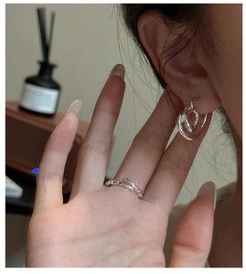 Close-up of S925 sterling silver knotted hoop earrings and matching lava style ring set