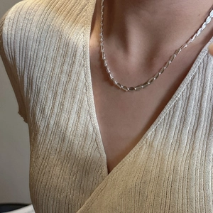 Minimalist S925 sterling silver frosted bead necklace on a model wearing beige knitwear