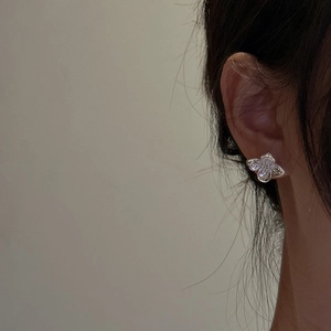 S925 sterling silver flower stud earrings with vintage floral design on model