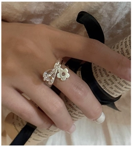Detail of S925 sterling silver ring with crystal bead and flower charm showing hallmark