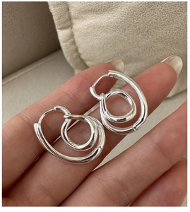 Detail of S925 sterling silver knot hoop earrings with interlocking twist design
