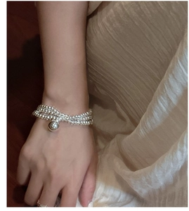 Detail of S925 sterling silver triple-layer beaded bracelet with large ball charm