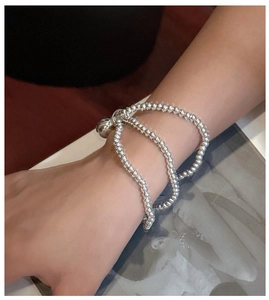 Close-up of S925 sterling silver triple-layer beaded bracelet with sphere charm