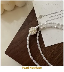 Detail of S925 silver clasp with lobster buckle and heart pendant on pearl necklace