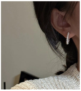 Detail of S925 sterling silver beaded hoop earring with small abacus beads on female model