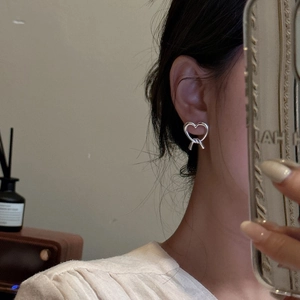 Minimalist S925 sterling silver matte heart stud earrings with knot design on earlobe