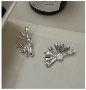 Detail of 925 sterling silver floral earrings with polished half-daisy petal design