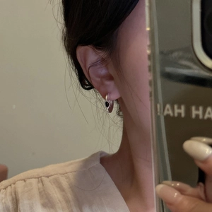 Minimalist 925 silver C-shape earrings with black agate inlay shown on model