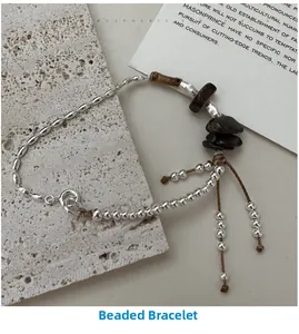 Close-up of S925 sterling silver beaded bracelet with natural stones and woven cord