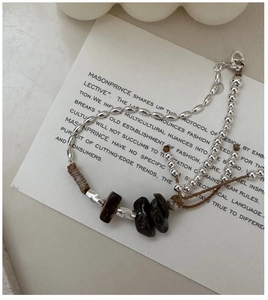 Detail of S925 sterling silver beaded bracelet with natural stone and woven cord