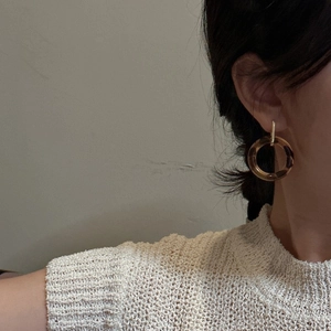 Elegant S925 silver gold leopard print resin earrings worn by a model in casual style