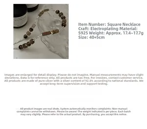 Detailed view of S925 silver necklace with tiger eye stone and wooden block beads