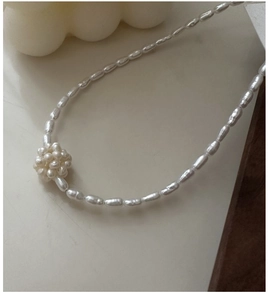 Close-up of S925 silver necklace with white freshwater rice pearls and a sphere pendant