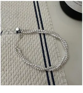 Detail of S925 sterling silver double-layer bead bracelet with heart charm and lobster clasp