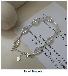 Detailed shot of S925 sterling silver pearl bracelet with lobster clasp and heart tag