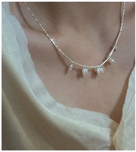 Detailed view of S925 sterling silver necklace with freshwater rice pearls on skin
