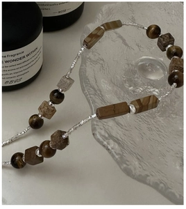 Detailed macro view of S925 sterling silver necklace with tiger eye stone beads