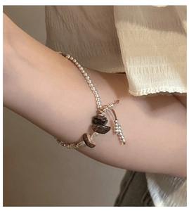 Close-up of S925 sterling silver beaded bracelet with natural stones on a woman wrist