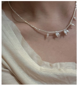 Close-up of S925 silver necklace featuring freshwater pearls on a delicate beaded chain