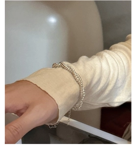 Close-up of double-layered S925 sterling silver beaded bracelet on a woman wrist