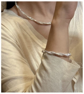 Close-up of double-layered S925 sterling silver beaded bracelet and necklace set