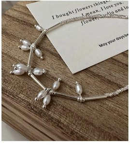 Detailed close-up of S925 sterling silver tube and baroque freshwater pearl necklace