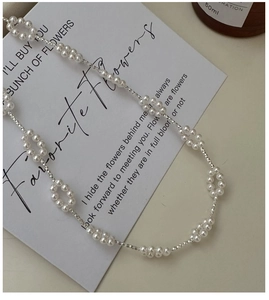 Detailed macro view of S925 silver beaded flower pearl necklace with vintage design