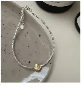 Close-up of S925 sterling silver beaded bracelet with heart tag and lobster clasp