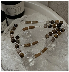 Detail of S925 silver necklace with tiger eye beads and textured rectangular stones