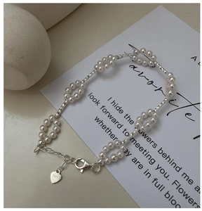 Detail of S925 silver pearl flower bracelet with lobster clasp and heart charm