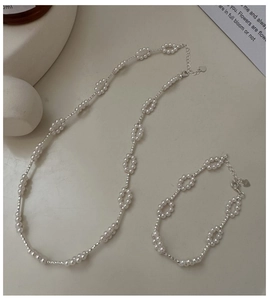 Detail of S925 silver pearl necklace and bracelet set with hollow oval links and heart charm