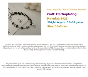 Detailed macro view of S925 silver beaded bracelet with tiger eye stones and lotus pendant