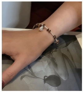 Detailed shot of vintage S925 silver bracelet with brown tiger eye stone beads on wrist