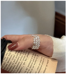 Detail of S925 sterling silver woven ring featuring a hollow mesh design on thumb