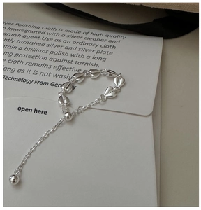 Close-up of S925 sterling silver chain ring with interlocking hearts and drop bead