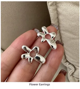 Close-up of S925 sterling silver earrings with abstract hollow flower design