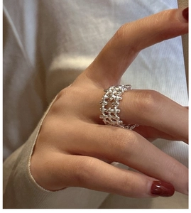 Detail shot of the silver woven texture ring showcasing intricate braided craft design