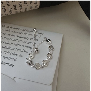 Detailed macro view of S925 sterling silver heart-shaped link pull ring on display card