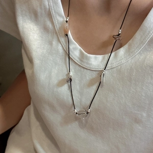 Handmade S925 sterling silver beaded long necklace with knot design on white t-shirt