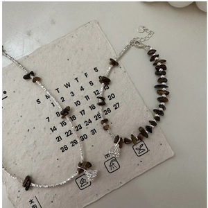 Detailed shot of S925 silver lotus pendant with tiger eye stone vintage bracelet