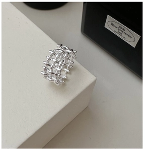 Close-up of S925 sterling silver woven ring on a minimalist display stand