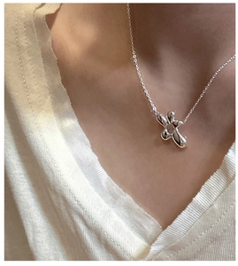 Close-up of S925 sterling silver flower pendant necklace on a model's collarbone