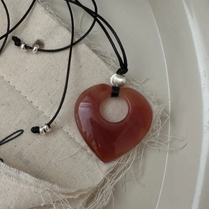 Collana cuore in argento S925 con agata rossa e cordino nero su panno di lino naturale