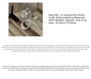 Detail of S925 sterling silver hoop earrings showing U-shaped design and material weight