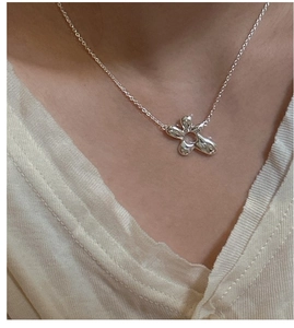 Detail of silver S925 irregular flower pendant on minimalist dainty choker necklace