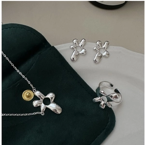 Detail view of silver liquid metal flower jewelry set with necklace and earrings