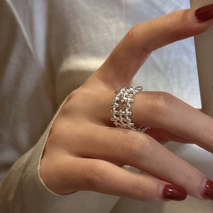 Minimalist S925 sterling silver woven ring featuring a hollow braided metal texture on a finger